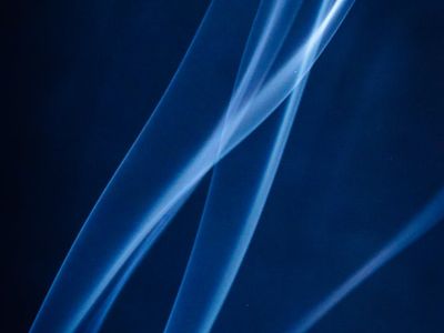 Abstract lines of light creating a sense of fluid motion on a dark background.