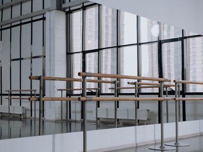 An empty, calm studio space with natural light coming from a large window.